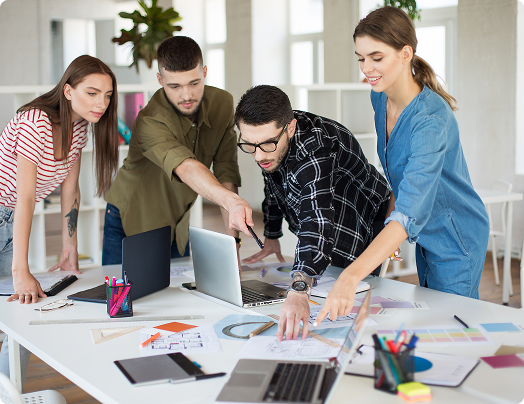 Team discussing numbers and flow in front of a presentation board