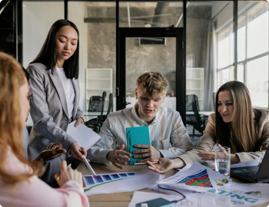 Team discussing numbers and flow in front of a presentation board