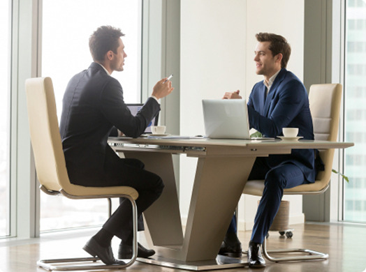 Team discussing numbers and flow in front of a presentation board