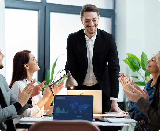 Team discussing numbers and flow in front of a presentation board