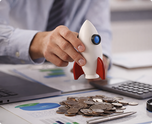 Team discussing numbers and flow in front of a presentation board