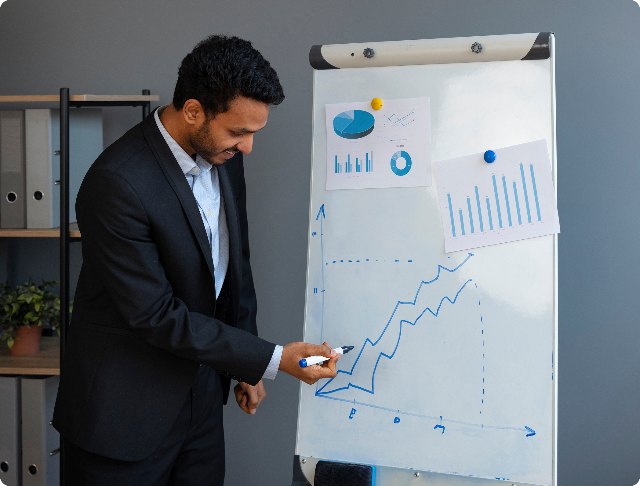 Business professional presenting growth strategy on whiteboard